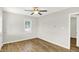 Bright bedroom featuring wood-look floors, a ceiling fan, and plenty of natural light at 1515 S Emerson Ave, Indianapolis, IN 46203