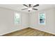 Bedroom with wood-look floors, lots of natural light, and ceiling fan at 1515 S Emerson Ave, Indianapolis, IN 46203