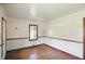 Simple bedroom with hardwood floors, neutral walls, and a window offering natural light at 1515 S Emerson Ave, Indianapolis, IN 46203
