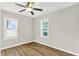 This cozy bedroom offers wood floors, fan and light fixture, with lots of light and neutral paint colors at 1515 S Emerson Ave, Indianapolis, IN 46203