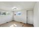 An empty bedroom with two windows and linoleum floors at 1515 S Emerson Ave, Indianapolis, IN 46203