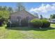 Single-story home featuring striped awnings, mature bushes, and well-kept lawn at 1515 S Emerson Ave, Indianapolis, IN 46203