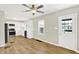 Open-concept kitchen boasts stainless steel appliances, white cabinetry, modern backsplash, and wood-look flooring at 1515 S Emerson Ave, Indianapolis, IN 46203