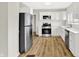 Bright kitchen features stainless steel appliances, white cabinetry, stylish backsplash, and modern flooring at 1515 S Emerson Ave, Indianapolis, IN 46203