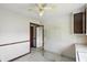 Small kitchen with dated cabinets, window view, and utility lighting at 1515 S Emerson Ave, Indianapolis, IN 46203