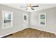 Spacious living room with hardwood floors, plenty of natural light, and a ceiling fan at 1515 S Emerson Ave, Indianapolis, IN 46203