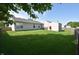 Backyard view showcasing lush green grass, privacy fence, and a convenient storage shed for outdoor equipment at 1652 Sweetwater Ln, Greenfield, IN 46140