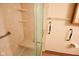 Accessible bathroom features grab bars, seat and shelves in the tiled walk in shower for convenience and safety at 1652 Sweetwater Ln, Greenfield, IN 46140