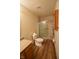 The bathroom features a glass-enclosed shower, wood-look flooring, and neutral walls at 1652 Sweetwater Ln, Greenfield, IN 46140