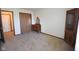 A bedroom features carpet, vintage furniture, a closet, and a door leading to another room at 1652 Sweetwater Ln, Greenfield, IN 46140