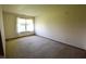 This carpeted bedroom includes a window for natural light and neutral colored walls at 1652 Sweetwater Ln, Greenfield, IN 46140