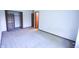 A carpeted bedroom includes a closet with shelving and an additional door leading to another room at 1652 Sweetwater Ln, Greenfield, IN 46140