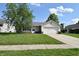 Charming single-story home featuring a well-maintained lawn and attached garage on a sunny day at 1652 Sweetwater Ln, Greenfield, IN 46140