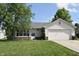 Charming single-story home with a well-maintained lawn and attached garage, offering comfortable suburban living at 1652 Sweetwater Ln, Greenfield, IN 46140