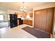 Kitchen with wood cabinets, black appliances, and eat in area at 1652 Sweetwater Ln, Greenfield, IN 46140