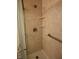 This tiled walk in shower features grab bars, built in seat and shelves for convenience and accessibility at 1652 Sweetwater Ln, Greenfield, IN 46140