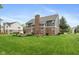 Large backyard featuring a garden, stone patio, and well-manicured lawn at 17002 Folly Brook Rd, Noblesville, IN 46060