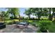 Serene backyard with a patio dining set, mature trees providing ample shade, and lush greenery, ideal for outdoor relaxation at 17002 Folly Brook Rd, Noblesville, IN 46060