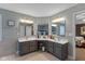 Bright bathroom features double vanity, modern mirrors, sinks, and a separate door leading to the bedroom at 17002 Folly Brook Rd, Noblesville, IN 46060