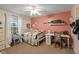 Cozy bedroom with pink accent wall, white furniture, and a window letting in natural light at 17002 Folly Brook Rd, Noblesville, IN 46060