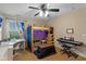 Bright bedroom featuring a loft bed, desk, keyboard, and window offering a pleasant view at 17002 Folly Brook Rd, Noblesville, IN 46060