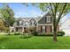 Charming two-story home with brick and gray siding, complemented by a well-maintained lawn and mature trees at 17002 Folly Brook Rd, Noblesville, IN 46060