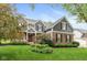 Charming two-story home with brick and gray siding, complemented by a well-maintained lawn and mature trees at 17002 Folly Brook Rd, Noblesville, IN 46060