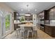 Spacious kitchen features a large island with seating, stainless steel appliances, and custom dark wood cabinetry at 17002 Folly Brook Rd, Noblesville, IN 46060