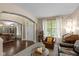 Inviting living room with hardwood floors, comfortable seating, and abundant natural light from large windows at 17002 Folly Brook Rd, Noblesville, IN 46060
