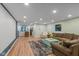 The basement living room boasts a large sofa, stylish rug, and recessed lighting for a cozy ambiance at 17002 Folly Brook Rd, Noblesville, IN 46060
