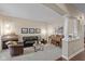 Inviting living room with hardwood floors, comfortable seating, and abundant natural light from large windows at 17002 Folly Brook Rd, Noblesville, IN 46060