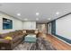 The expansive living room features a comfortable sofa, stylish rug, and recessed lighting for a cozy ambiance at 17002 Folly Brook Rd, Noblesville, IN 46060