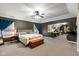 Spacious main bedroom with sitting area, decorative quilt, and access to an office space at 17002 Folly Brook Rd, Noblesville, IN 46060