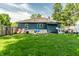 Expansive backyard with lush lawn, play set, and a privacy fence creating a private retreat at 1747 S Irvington Ave, Indianapolis, IN 46203