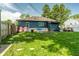 View of a grassy backyard featuring fencing, play sets, and some lawn chairs at 1747 S Irvington Ave, Indianapolis, IN 46203