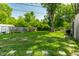 View of a grassy backyard with a playset and an enclosed fence at 1747 S Irvington Ave, Indianapolis, IN 46203