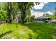 A grassy backyard featuring trees, a shed, and a play set for  at 1747 S Irvington Ave, Indianapolis, IN 46203