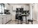Open kitchen with stainless appliances, overhead cabinets and black breakfast table set at 1747 S Irvington Ave, Indianapolis, IN 46203