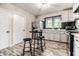 Updated kitchen features stainless steel appliances, stylish backsplash, and a cozy breakfast nook at 1747 S Irvington Ave, Indianapolis, IN 46203