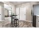 Bright kitchen with modern black stools and black appliances overlooking the living room at 1747 S Irvington Ave, Indianapolis, IN 46203