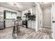 Charming kitchen featuring white cabinets, black subway tile backsplash, and modern stainless steel appliances at 1747 S Irvington Ave, Indianapolis, IN 46203