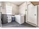 Functional laundry area with washer, dryer, utility sink, and ample storage space at 1747 S Irvington Ave, Indianapolis, IN 46203
