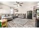 Cozy living room featuring stylish sectional sofa, ceiling fan and contemporary rug at 1747 S Irvington Ave, Indianapolis, IN 46203