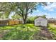Large backyard featuring a wooden fence and an old garage at 1852 N Warman Ave, Indianapolis, IN 46222
