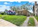 A single-Gathering home with a well-maintained lawn and a gravel driveway at 1852 N Warman Ave, Indianapolis, IN 46222