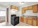 Compact eat-in kitchen, featuring wood cabinets and linoleum floors at 1852 N Warman Ave, Indianapolis, IN 46222