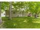 Well-maintained backyard featuring a lush lawn and mature trees providing ample shade at 1941 Orchard Ct, Carmel, IN 46280