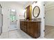 Well-lit bathroom featuring wood vanity with double sinks and tiled backsplash at 1941 Orchard Ct, Carmel, IN 46280