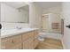 Bathroom with neutral walls, light wood floors, vanity, toilet and shower at 1941 Orchard Ct, Carmel, IN 46280