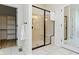 Bathroom boasts glass shower with a built-in bench and tiled floor at 1941 Orchard Ct, Carmel, IN 46280